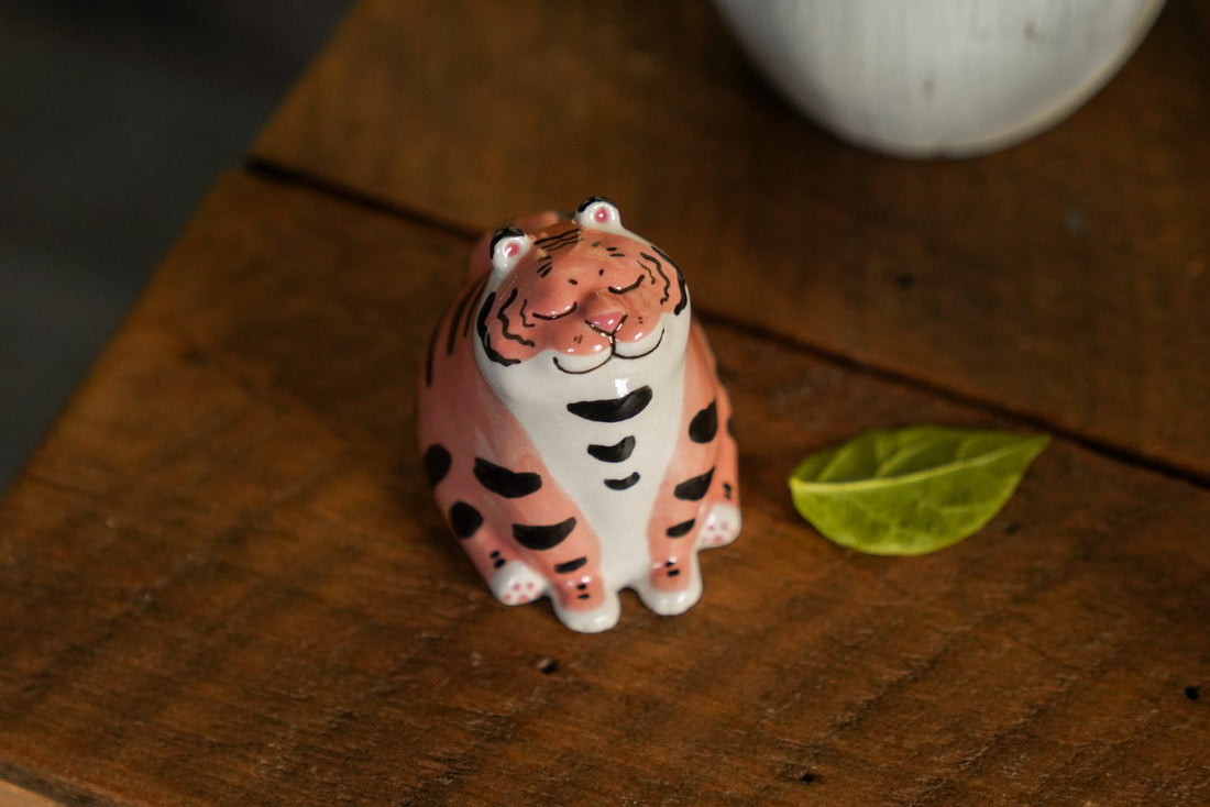 tea pet tiger sitting and smiling