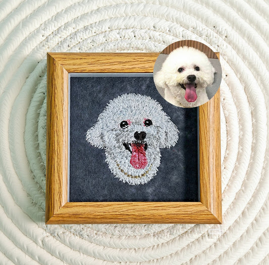 Framed needlepoint of a dog's face next to a photo of a real dog with a wooden frame.