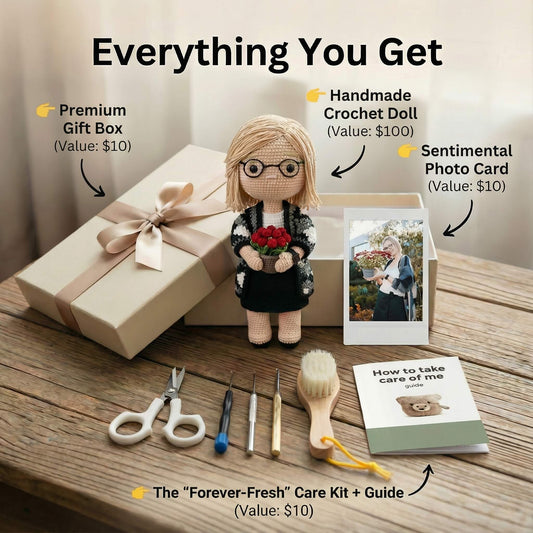 Gift set with a crochet doll, photo card, gift box, and care kit on a wooden surface.